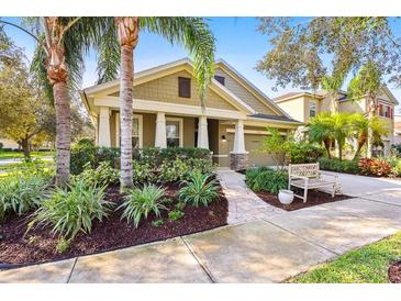 Craftsman style home with landscaped front yard, stone accents, and a welcoming porch at 15811 Oakleaf Run Dr, Lithia, FL 33547