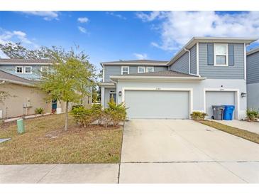 Two-story townhome with gray exterior and attached garage at 2146 Laceflower Dr, Brandon, FL 33510