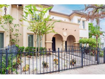 Attractive 2-story home with arched entry and gated front yard at 3817 W Dale Ave # 2, Tampa, FL 33609