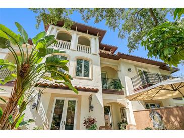 Inviting three-story home with balconies and lush landscaping at 3833 W Azeele St, Tampa, FL 33609