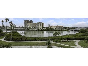 Aerial view of waterfront community with tennis courts, pool, and marina at 7893 Sailboat Key S Blvd # 304, South Pasadena, FL 33707