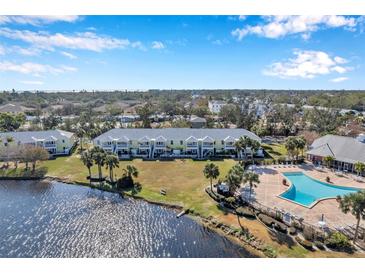Aerial view of a waterfront community with a pool and lush landscaping at 107 Seahorse Se Dr # A, St Petersburg, FL 33705