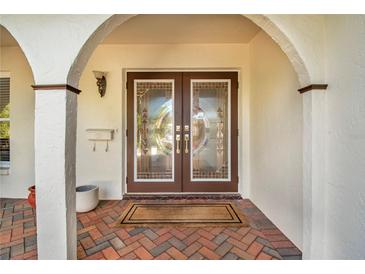 Inviting front entry featuring double doors and brick walkway at 1200 80Th S St, St Petersburg, FL 33707