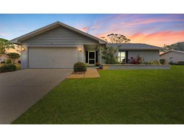 Newly painted house with a large yard and attached garage at 1383 Glengarry Dr, Palm Harbor, FL 34684