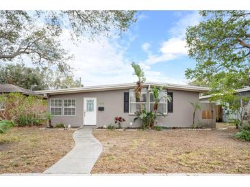 Gray house with white door, landscaping, and walkway at 1642 49Th N Ave, St Petersburg, FL 33714