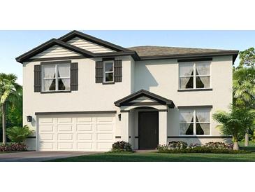 Two-story house with white siding, dark gray accents, and a two-car garage at 17355 Wheatberry Blvd, Parrish, FL 34219