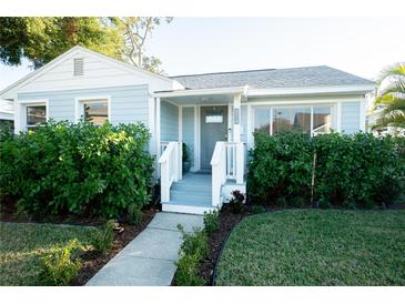 Charming light blue house with white trim and a landscaped front yard at 434 29Th N Ave, St Petersburg, FL 33704