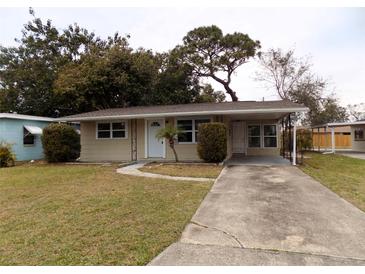 Tan single story home with carport and small yard at 435 92Nd N Ave, St Petersburg, FL 33702