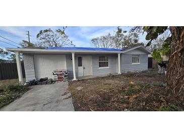 Newly painted house with a carport and landscaping at 5005 Drift Tide Dr, New Port Richey, FL 34652
