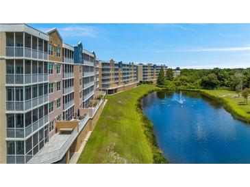 Beautiful condominiums overlooking a serene lake with a fountain and lush green surroundings at 960 Starkey Rd # 7103, Largo, FL 33771