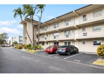 Two-story condo building with parking and tropical landscaping at 9940 47Th N Ave # 120, St Petersburg, FL 33708
