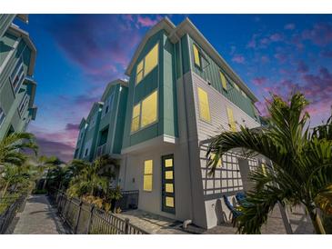 Modern three-story townhome with light teal exterior and private patio at 2819 1St S Ave, St Petersburg, FL 33712