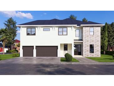 Two-story house with stone accents and a two-car garage at 4009 W Euclid Ave, Tampa, FL 33629