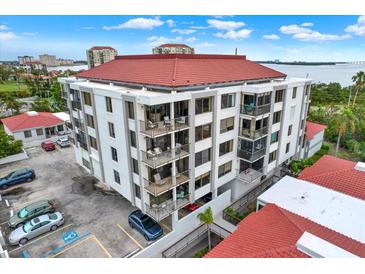 Aerial view of a condo building with red tile roofs and ample parking at 6365 Bahia Del Mar Blvd # 604, St Petersburg, FL 33715