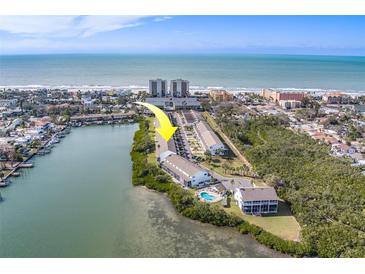 Aerial view of waterfront property, showing community pool and ocean access at 905 Hidden Harbour Dr, Indian Rocks Beach, FL 33785