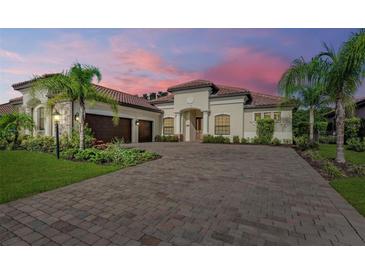 Two-story home with a three-car garage and a brick driveway at 13819 Swiftwater Way, Bradenton, FL 34211
