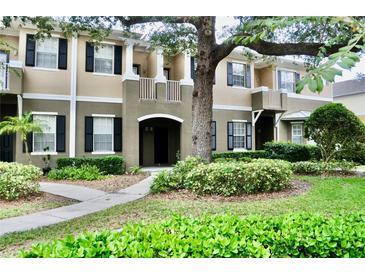 Two-story townhome with landscaping and walkway at 14003 Citrus Crest Cir, Tampa, FL 33625