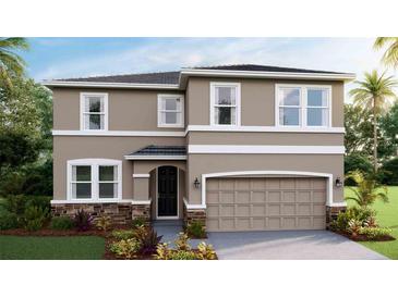 Two-story home with a two-car garage, stone accents, and landscaping at 17932 Tavernside Trl, Lakewood Ranch, FL 34211