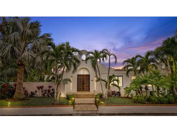 Spanish style home with palm trees and a landscaped yard at 220 14Th N Ave, St Petersburg, FL 33701