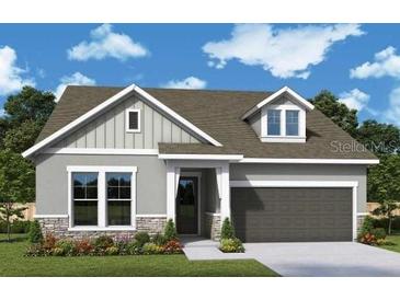 Attractive one-story home with gray siding and stone accents at 5283 Everlong Dr, Apollo Beach, FL 33572
