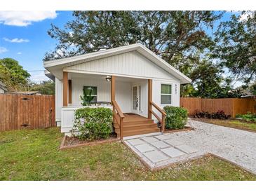 Charming white cottage with brown accents and a welcoming front porch at 6297 29Th N St, St Petersburg, FL 33702