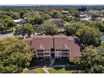 Aerial view of condo building showcasing its layout and landscaping at 1550 S Belcher Rd # 117, Clearwater, FL 33764