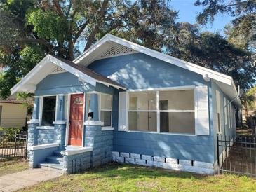 Newly painted blue house with a red door and a small front yard at 2035 11Th S St, St Petersburg, FL 33705