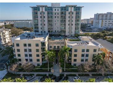 Aerial view of a modern, multi-story residential building with a pool and ample parking at 400 4Th S Ave # 506, St Petersburg, FL 33701