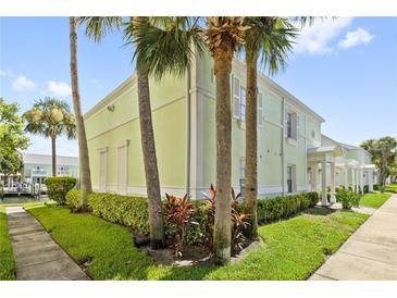 Light green building exterior with palm trees and landscaping at 5012 Starfish Se Dr # C, St Petersburg, FL 33705