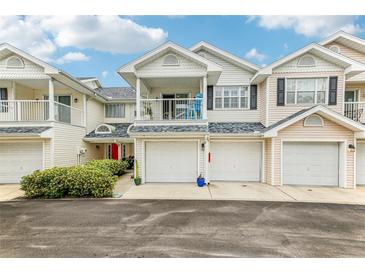 Two-story townhome with attached garage and balcony at 505 Ashley Dr, Dunedin, FL 34698