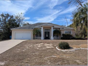 Single-story home with attached garage and landscaping at 2365 Ardenwood Dr, Spring Hill, FL 34609