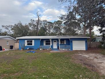 Cute blue house with carport and small front yard at 4933 Venetian Ne Blvd, St Petersburg, FL 33703
