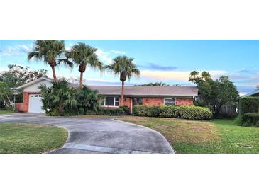 Brick home with palm trees, driveway, and landscaped yard at 6773 14Th N Ave, St Petersburg, FL 33710