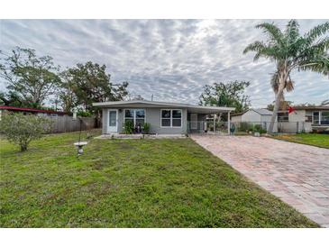 Cute bungalow with brick paver driveway and well-manicured lawn at 3645 Lokai Pl, Sarasota, FL 34232