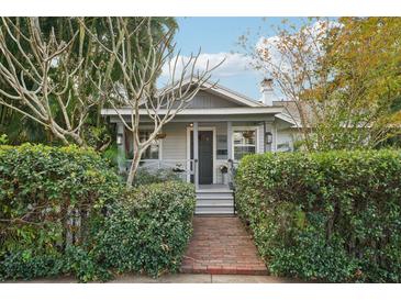 Charming house with gray siding, brick walkway, and lush landscaping at 934 21St N Ave, St Petersburg, FL 33704