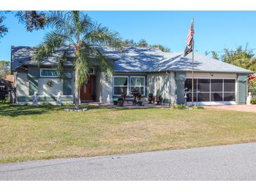 House exterior featuring a well-maintained lawn and a two-car garage at 2297 Anchor Ave, Spring Hill, FL 34608