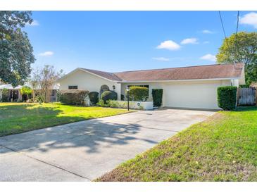 Single-story house with driveway, landscaped lawn, and attached garage at 4345 Union Springs Rd, Spring Hill, FL 34608