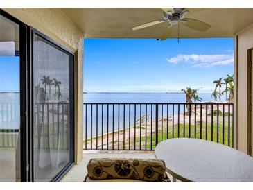 Enjoy the coastal scenery from this condo's balcony, overlooking the ocean and palm trees at 6322 Palma Del Mar S Blvd # 209, St Petersburg, FL 33715
