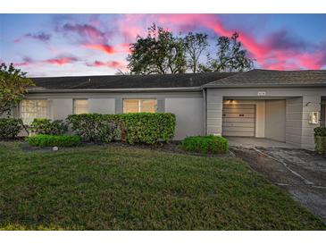 Front view of charming house with well-maintained landscaping at 8236 Brentwood Rd, Seminole, FL 33777