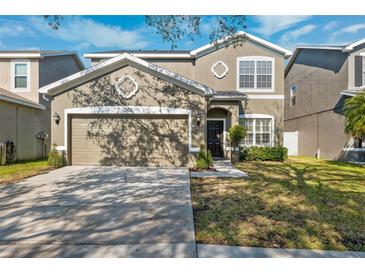 Two-story house with a two-car garage and landscaped lawn at 12509 Bay Branch Ct, Tampa, FL 33635