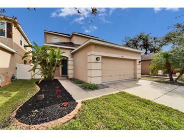 Two-story house with a two-car garage and well-maintained landscaping at 12610 Geneva Glade Dr, Riverview, FL 33578