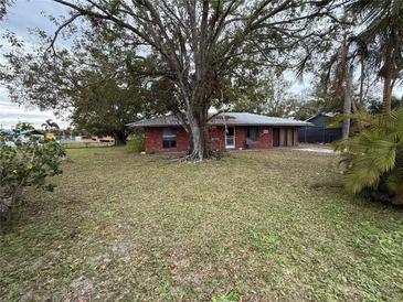 Brick home with mature tree and large front yard at 1417 Murillo Loop, Ruskin, FL 33570