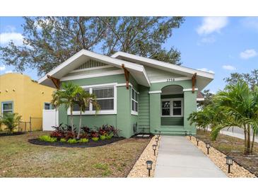 Charming bungalow with green exterior, landscaping, and walkway at 2758 3Rd S Ave, St Petersburg, FL 33712