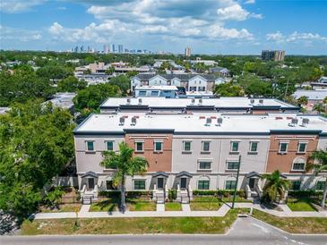 Aerial view of townhouses with city skyline in background at 3421 W Horatio St # 109, Tampa, FL 33609