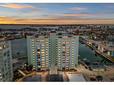 Aerial view of waterfront condo building at sunset at 400 64Th Ave # 502, St Pete Beach, FL 33706