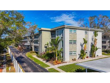 Two-story condo building with lush landscaping and ample parking at 5890 38Th N Ave # 101, St Petersburg, FL 33710