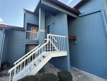 Exterior view of a light blue building with white stairs at 7724 St Andrews Blvd, Weeki Wachee, FL 34613