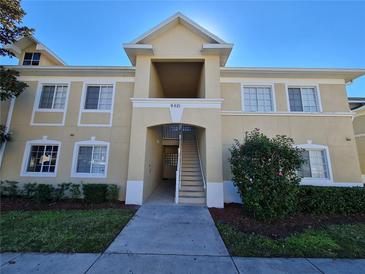 Inviting condo building exterior with landscaping and a staircase at 9521 Grovedale Cir # 201, Riverview, FL 33578