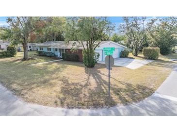 Ranch style home with brick facade and attached garage at 11012 N Oregon Ave, Tampa, FL 33612