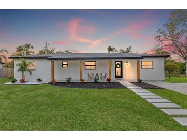 Stunning curb appeal! This newly renovated home features a modern design, lush landscaping, and a welcoming front porch at 1400 Farragut Dr, St Petersburg, FL 33710